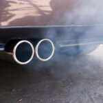 Car exhaust pipe expelling smoke